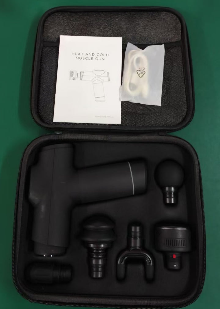 Black massage gun set with accessories and instructions in a black case on a green background